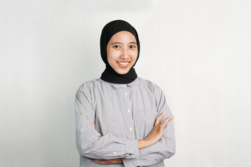 Confident Smiling Woman with Arms Crossed on White Background