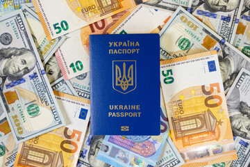 ukraine passport on a pile of euro and us dollar banknotes, travel and global finance concept