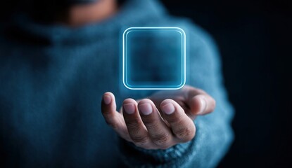 Human hand holding a glowing digital square, representing new technology and innovation concepts.