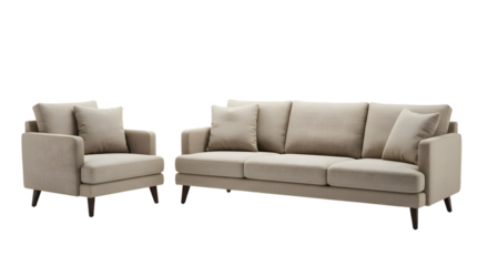 A beige sofa and armchair set with pillows against a dark background in a studio setting indoors