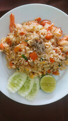 Delicious shrimp fried rice featuring fresh cucumber and lime, highlighting the vibrant flavors of a beloved Thai dish