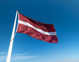 The Latvian flag waving high against a clear blue sky, symbolizing pride and cultural heritage.