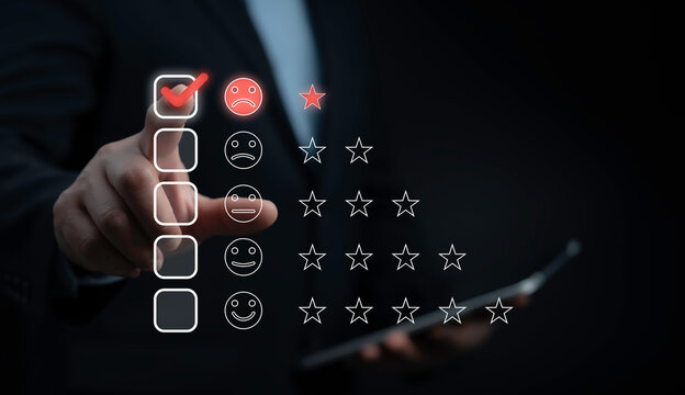 Hand selects a sad face with a one star rating on a digital interface, illustrating poor customer experience and negative service feedback