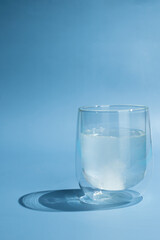 the effervescent tablet dissolves in a glass of water