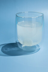the effervescent tablet dissolves in a glass of water