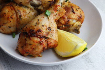 Grilled chicken. Spicy grilled chicken legs, drumsticks  on the white plate.