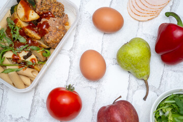 Top view of a healthy and delicious lunchbox with vegetables, fruits, and meat—perfect for work meals, meal prep, and eating healthy on the go. Ideal for fitness, wellness, and diet-focused content.