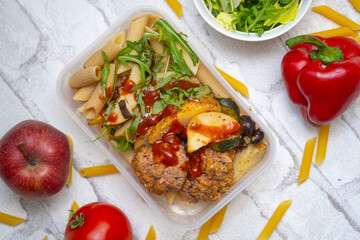 Balanced and tasty lunchbox next to fresh fruits and vegetables—perfect for healthy eating, calorie counting, and meal prep inspiration. Ideal for wellness, fitness, and nutrition-focused content.