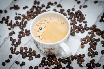 Top-down view of a delicious cup of coffee next to scattered coffee beans—perfect for café promotions, morning routines, and coffee lover content. Warm, inviting, and full of aroma.