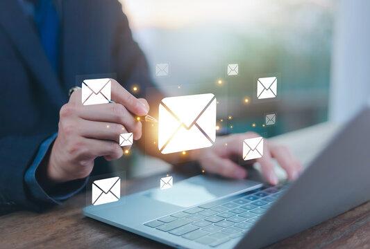 New email notification concept, business online communication, email communication, digital marketing, businessman responding to floating digital interface showing new email notification symbol.	
