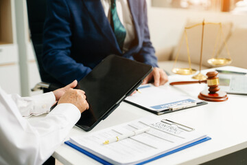 Business and lawyers discussing contract papers with brass scale on desk in office. Law, legal services, advice