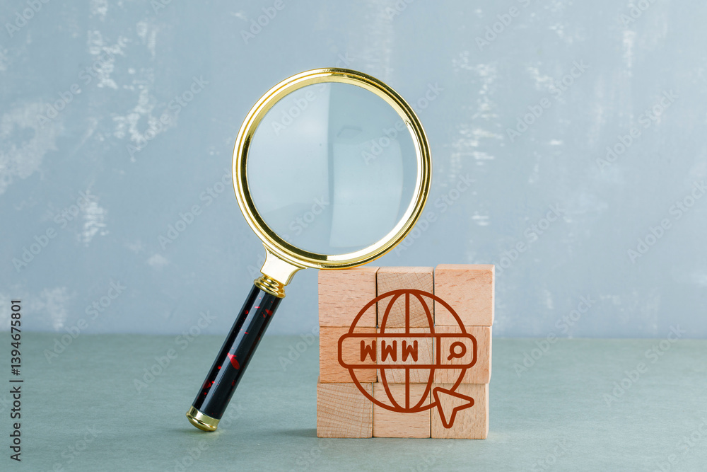 Poster conceptual of internet search with wooden blocks with internet icon, magnifying glass side view.