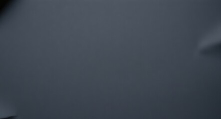 Paper surface background.  a blurry image of a gray surface with some indistinct shapes in the corners of frame