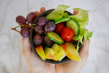 A plate with a variety of fresh fruits and vegetables, rich in vitamins. Healthy lifestyle, proper nutrition, balanced diet, organic food, vegan, nutritious, and vibrant.