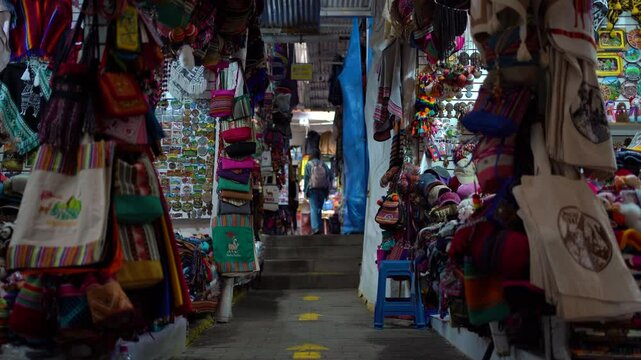 Young Woman Exploring Colorful Artisan Market in Aguas Calientes, Peru