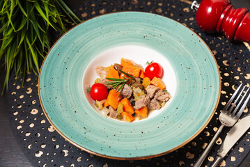 Gourmet meat and vegetable stew in bowl.