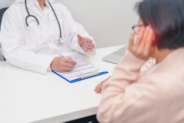Elderly woman Patient having Earache and consulting Doctor to Ear disease. Senior Health Medical...
