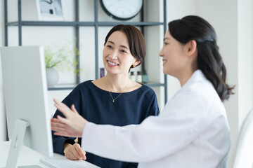 美容外科で診察を受けるミドルの女性