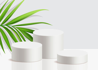 Three white podiums with palm leaf on a neutral background, ideal for product display or any seasonal products