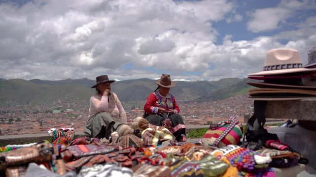 Peruvian Women Selling Handmade Textiles with Cusco City View