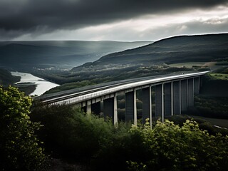 Obraz premium Bridge Over the Mountains in Dramatic Light