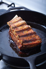 Pork ribs on a cast-iron skillet.