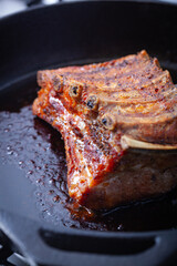 Pork ribs on a cast-iron skillet.