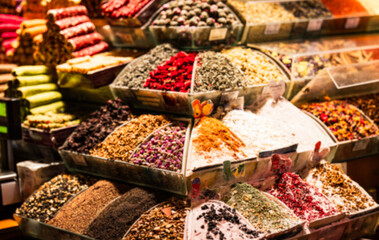 Out-of-focus image showing a variety of colorful spices and teas displayed at a stall in the Grand Bazaar, Istanbul, Turkey