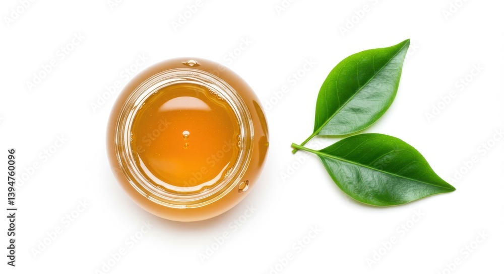 Poster a top view of a jar of honey with two green leaves on a white background in a studio setting isolate