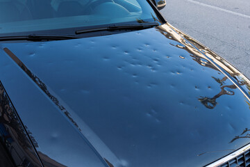 car hood hit by hail. storm damage