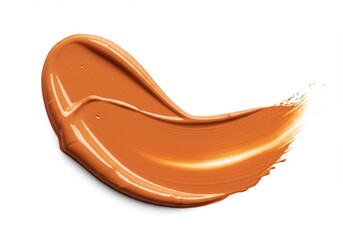 A single swipe of caramel colored foundation makeup on a plain white background in a studio setting isolated on white background