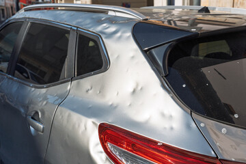 side of car hit by hail. storm damage