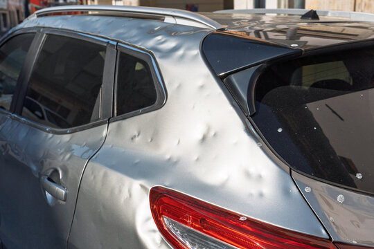 side of car hit by hail. storm damage