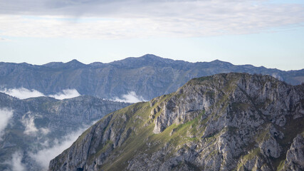 Stunning mountain panorama with the sunlight comming through the clouds on a partially cloudy sky