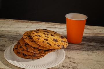 A cookie on the edge of a plate, ready to fall. Embodies the struggle between indulgence and...