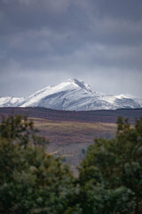 Imposing mountain peak covered with snow on a cloudy day