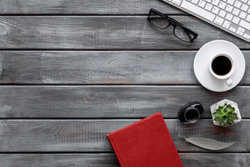 Top view of laptop keyboard and inkwell. Writer or blogger working space desktop