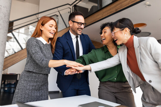 Collaborative Team Celebrating Success in Modern Office Setting