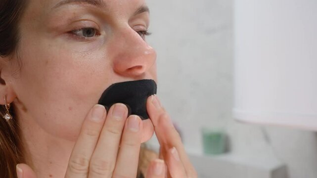 Woman Testing Breathable Mouth Tape That Loosens from Lips While Opening Mouth in Close-Up Shot for Product Quality Check Concept