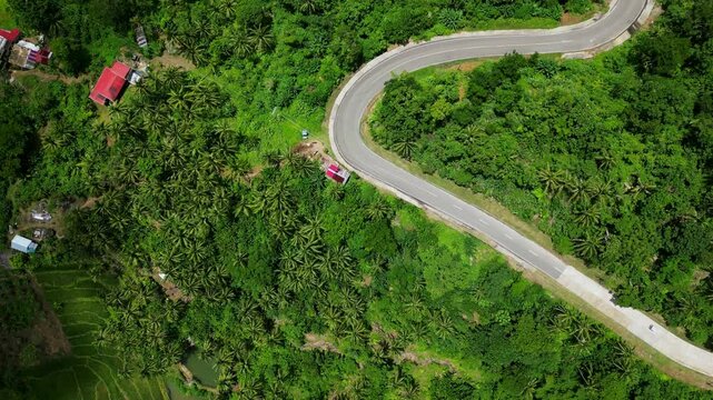 Winding Roads Through Tropical Nature Landscape In The Rural Town Of Bato, Catanduanes, Philippines. Aerial Topdown Shot