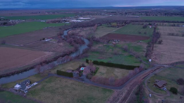 Drone orbit over farmland and Umatilla River in Hermiston, Oregon at dusk.