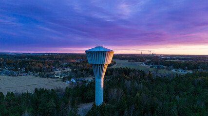 Sunset and play of light on the water tower. Raisio water tower. 

