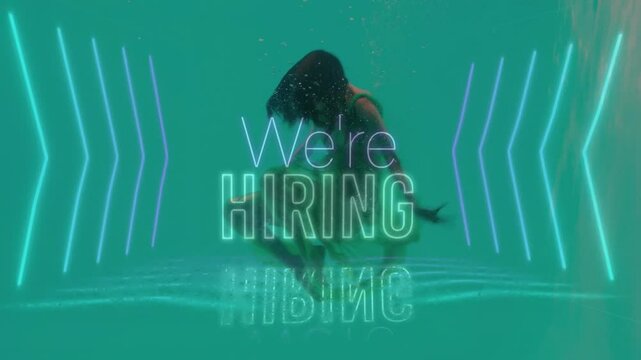 Underwater, person surrounded by glowing arrows and We're Hiring animation text