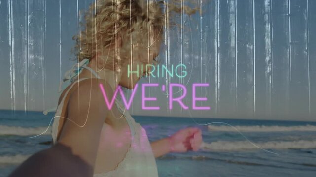 Dancing on beach, person with animation overlay saying We're Hiring