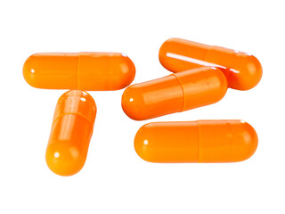 Bulk orange capsule pills isolated on white background.
