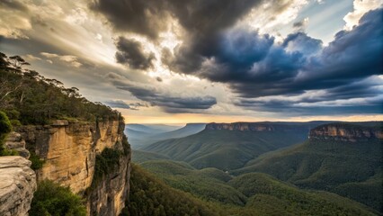 Naklejka premium Stunning landscape with dramatic clouds over mountainous terrain at sunset.