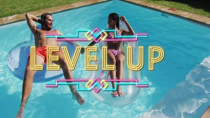 Couple relaxing on pool floats with Level Up text animation overlay - Powered by Adobe