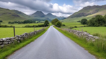Fototapeta premium Rural road through lush countryside, leading to mountains
