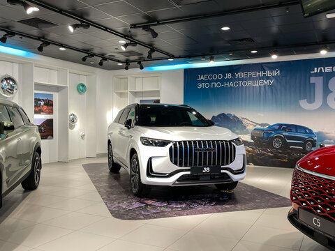 White Jaecoo J8 crossover in the showroom. Jaecoo J8 electric SUV displayed at car store. Chinese Motor Corporation. Jaecoo is an automobile manufacturer. 