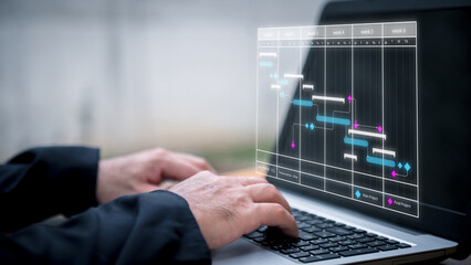 Scheduling activities with a planning software, Corporate strategy for finance, operations, sales, marketing. Project manager working with Gantt chart schedule to plan tasks and deliverables.